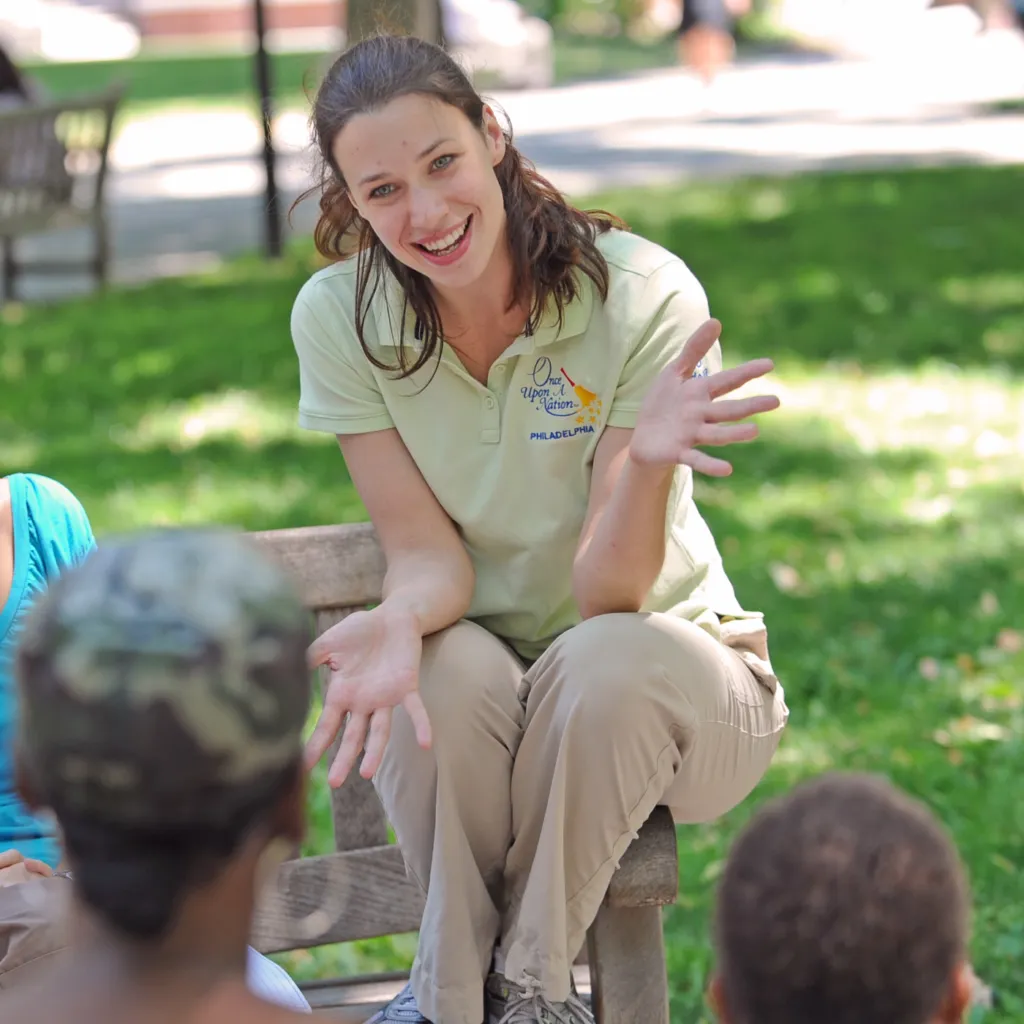 A Storyteller entertains guests at one of the storytelling benches along a stop of the Once Upon A Nation tours