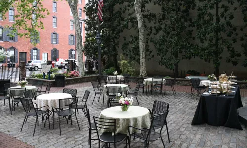 The Betsy Ross House courtyard shown with tables decorated for an event