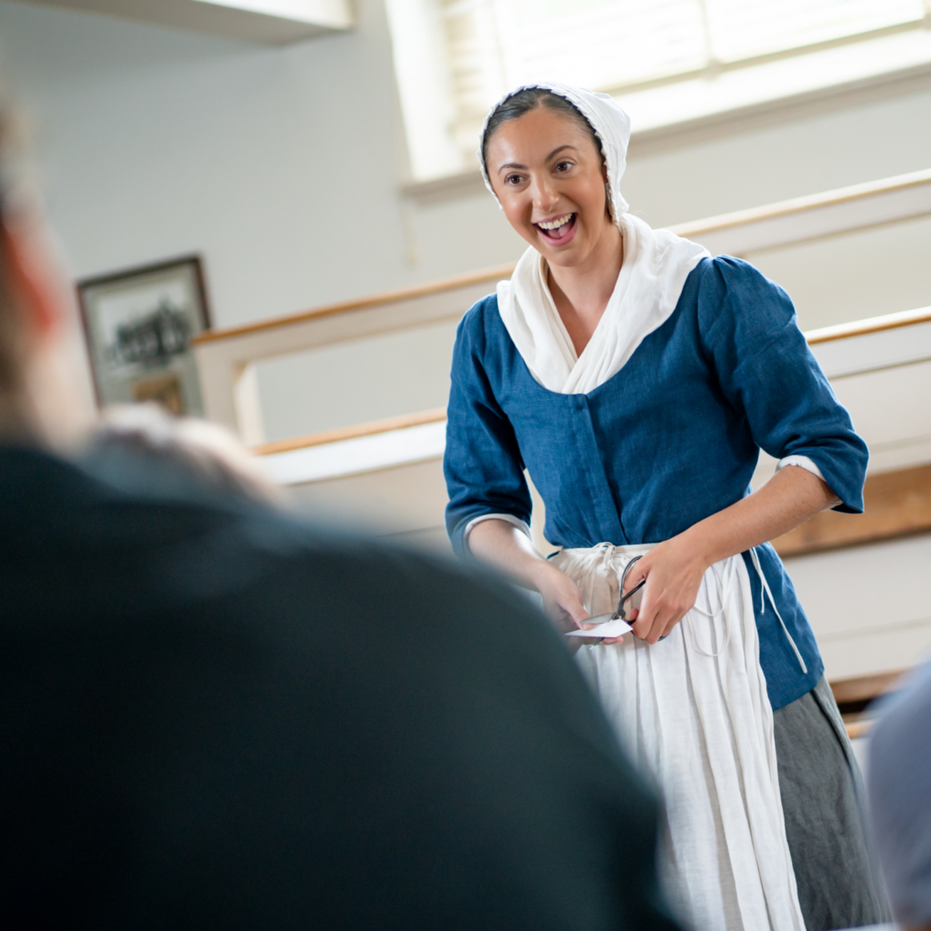 A History Maker portraying Betsy Ross speaks to a group