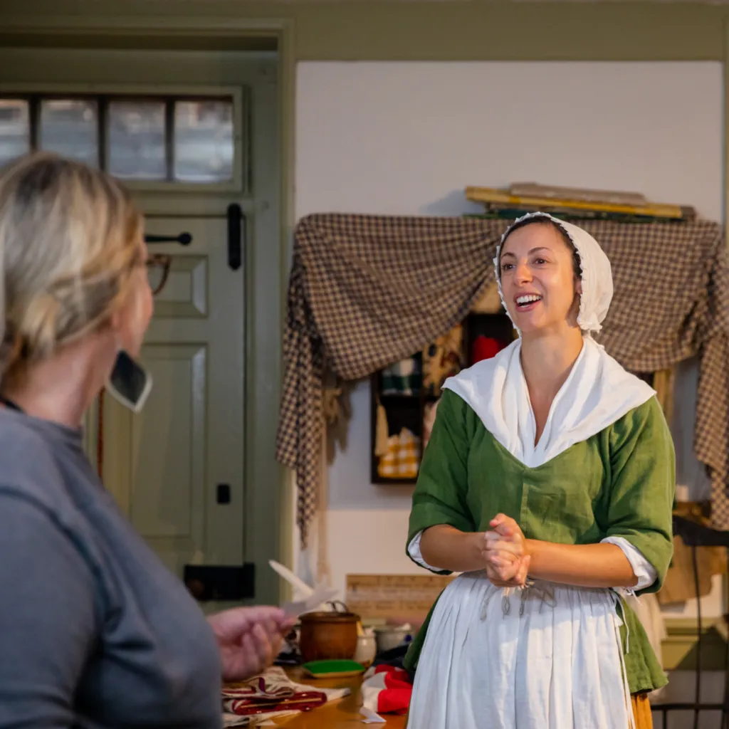A History Maker portratying Betsy Ross interacts with visitors in Betsy's upholstery shop at the Betsy Ross House