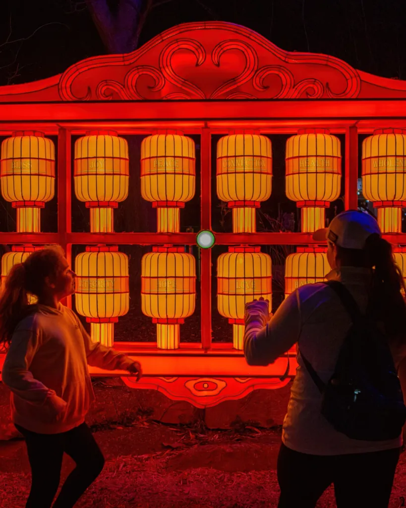 Young girls stand in front of the fortune telling wall at the Philadelphia Chinese Lantern Festival