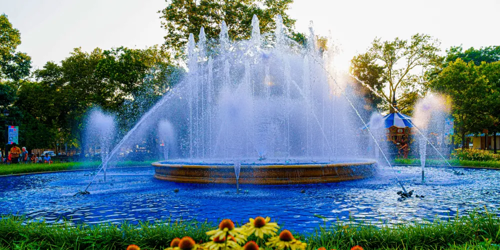 The Franklin Square fountain during the daytime with flowers blooming in the foreground