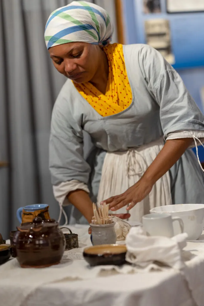 History Maker portraying Margaret Woodby rolls dough in the kitchen