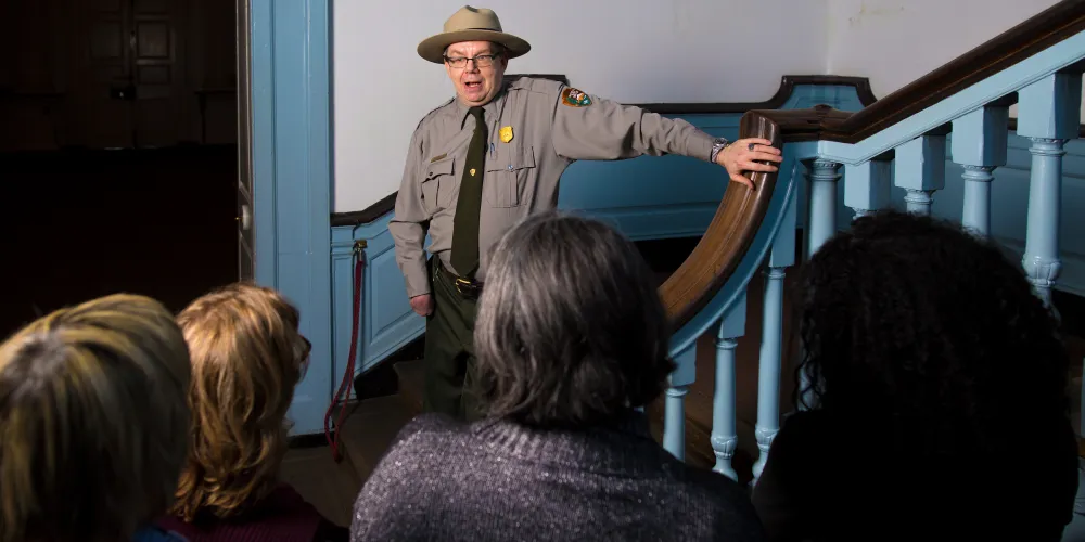 A National Park Service representative speaks with a tour group