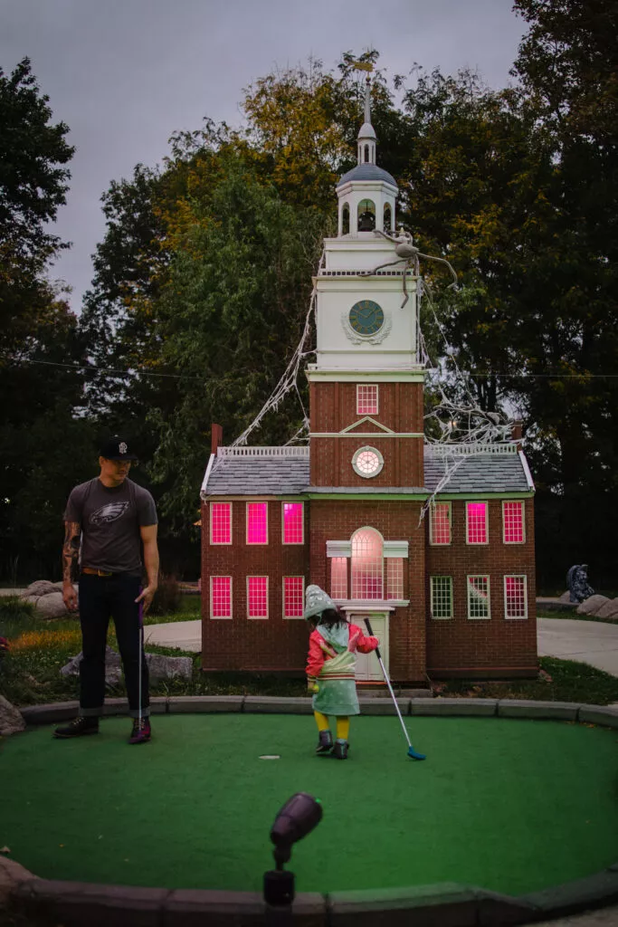 Photo of a father and daughter on the Spooky Mini Golf Course in Franklin Square.